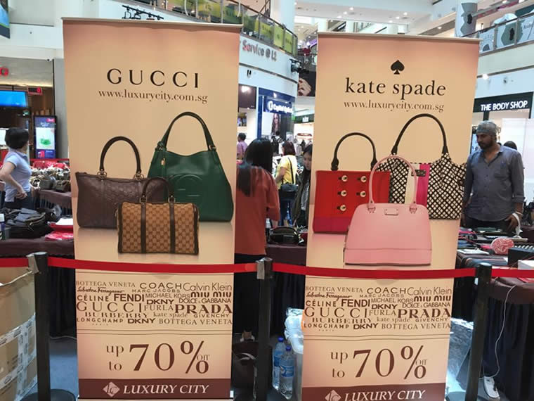 Luxury designer handbags on display in a Singapore shopping mall